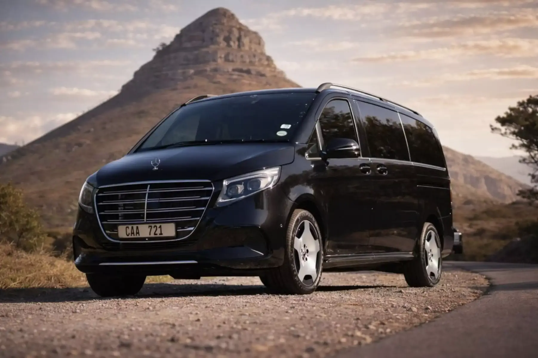 Professional Velmora Executive chauffeur beside luxury vehicle Cape Town